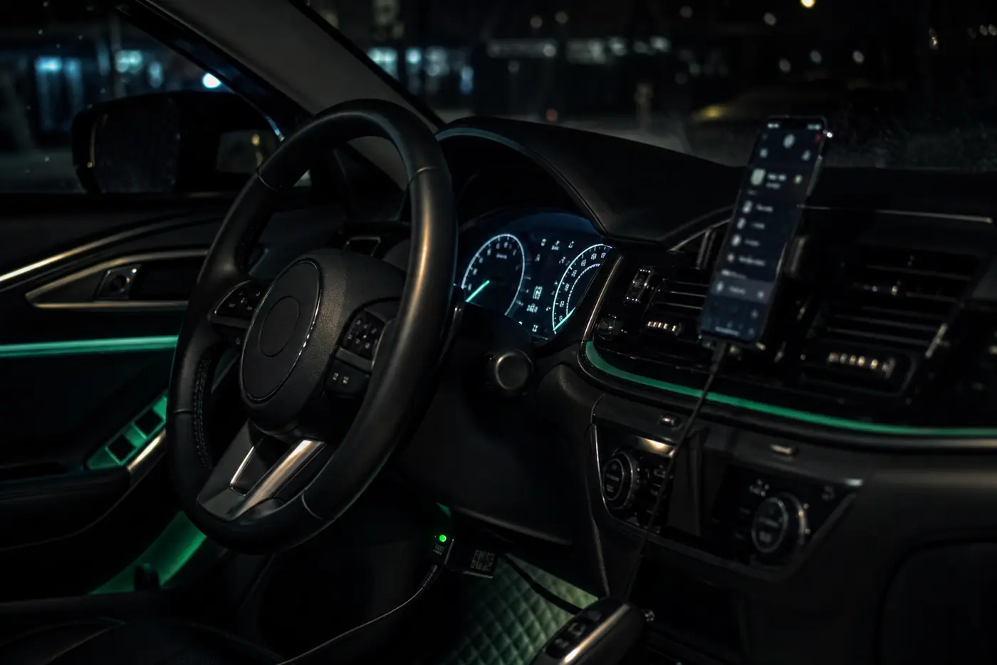 A car interior at night with an EcoDrive device glowing green